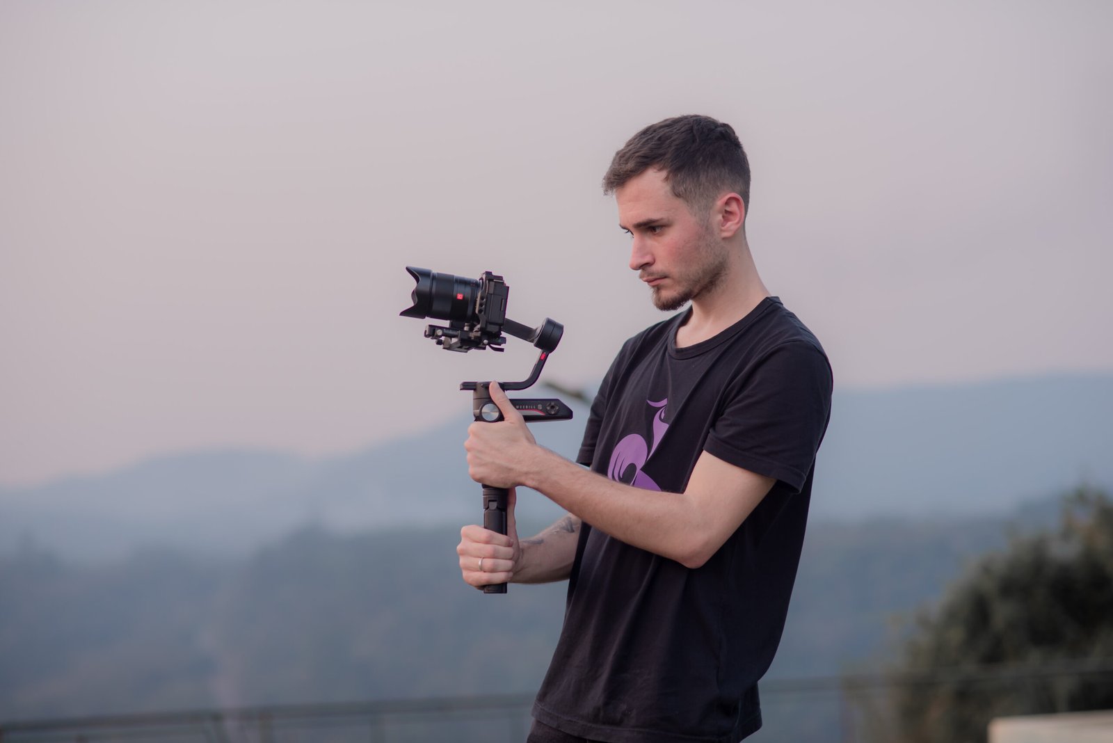A professional videographer capturing event footage with a gimbal